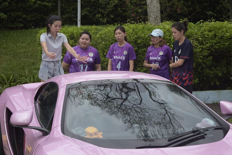 Volunteers listening to briefing at car wash